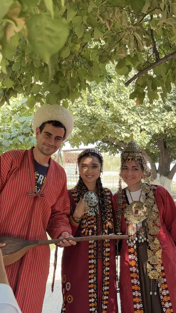 Travelers in Turkmen national dress with a dutar